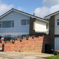 An image showing a metal hand rail we created for the ramp outside a house