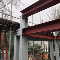 An image showing some metal I beams we fabricated now being used to create a building